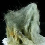 Cristales en forma de pelo de Clinozoisita verdosa en una densa masa de cristal